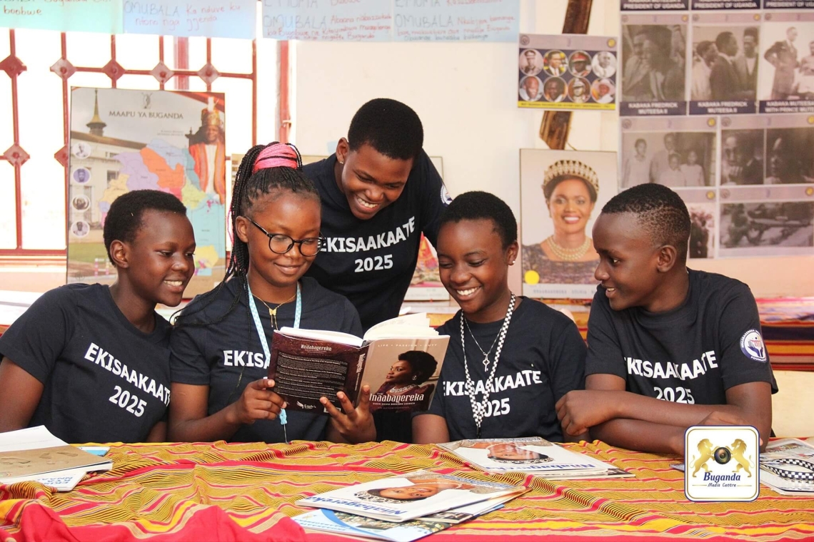 Abasaakaate participants reading books about Buganda traditions and cultural heritage, including crafts and customs